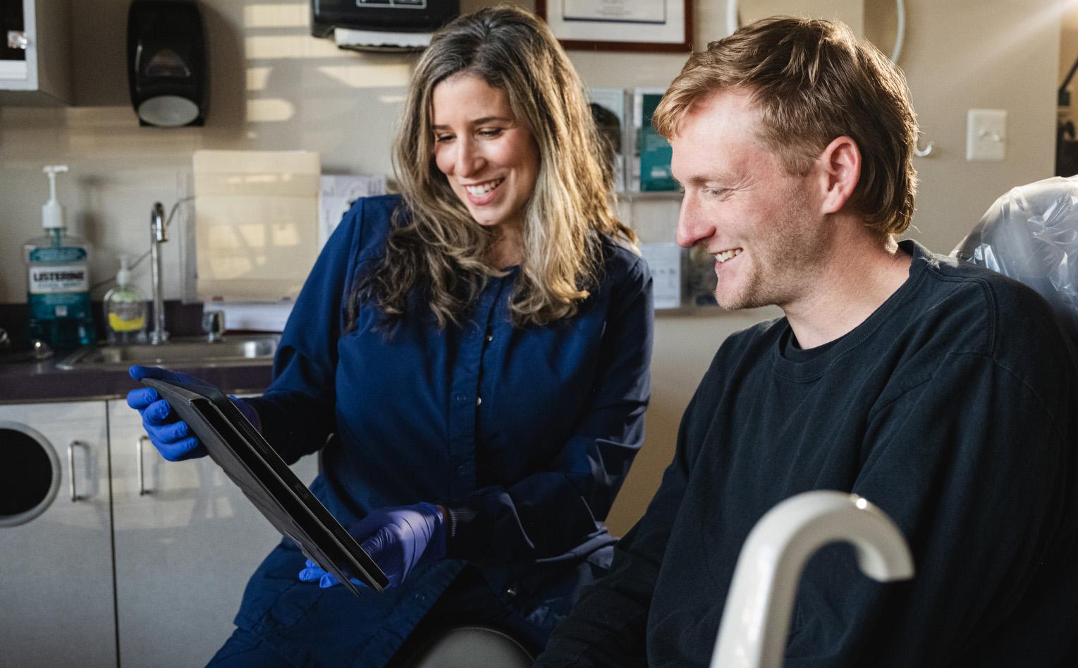 Dentist and patient looking at a screen